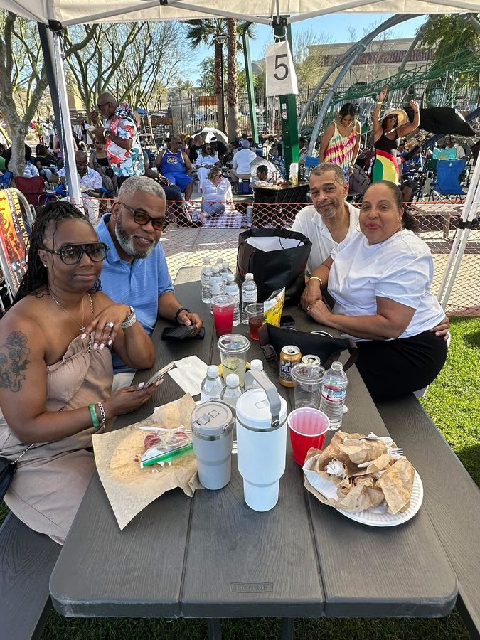 Food and drinks laid out on a picnic table
