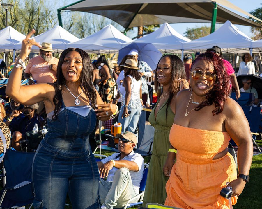 Four friends standing together at the festival