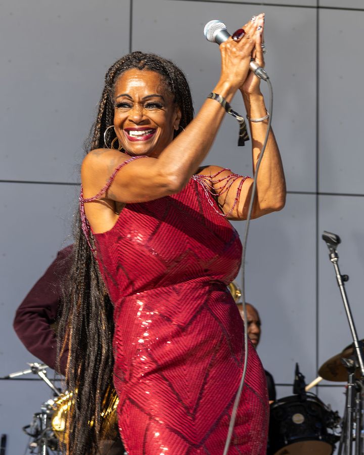 A vocalist in red performing