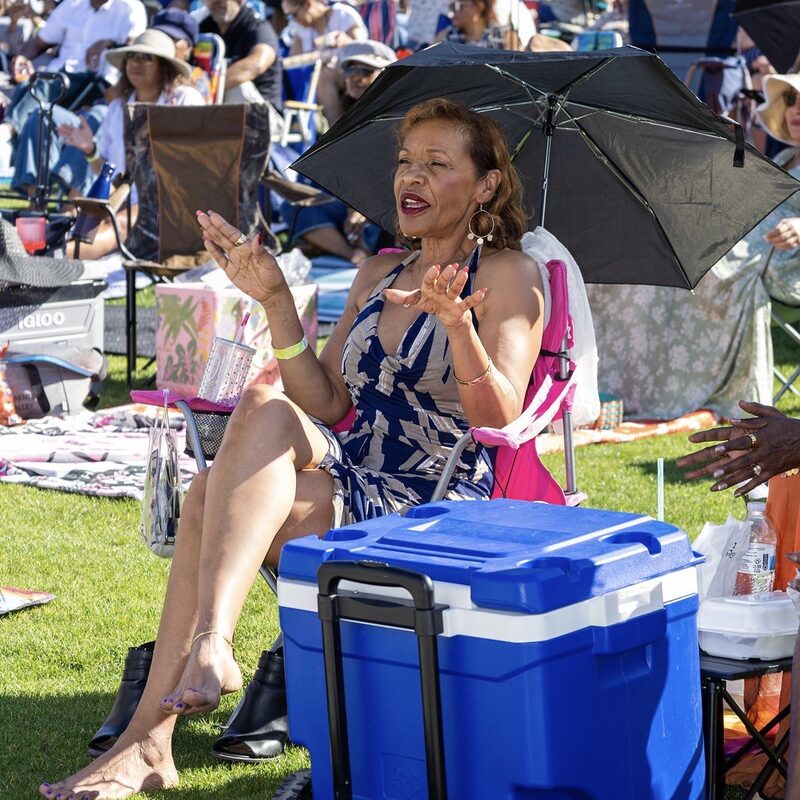 A guest dancing under a fringed parasol