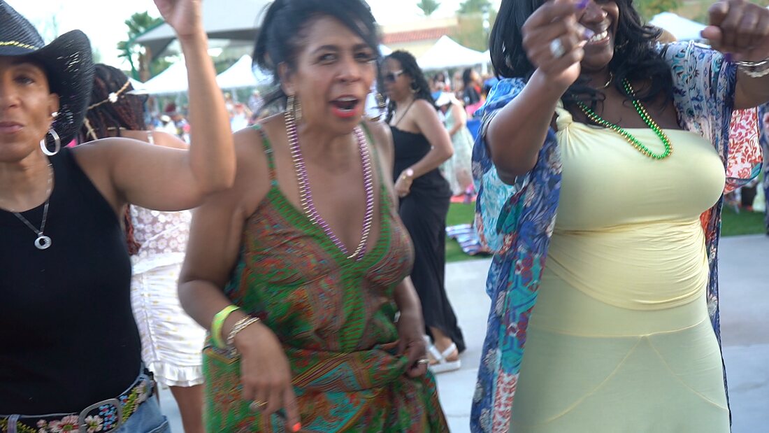 Three guests dancing together in the crowd