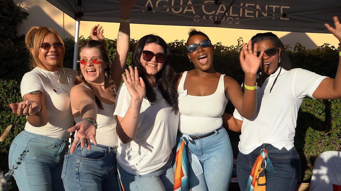 Five guests cheering together under the Agua Caliente Casinos banner