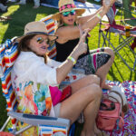 Friends in sun hats cheering from lawn chairs at Soul Springs Festival