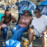 Friends relaxing together in shaded lawn chairs at Soul Springs Festival
