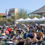 Crowd seated under festival tents enjoying live music at Soul Springs Festival