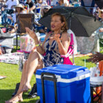 Woman enjoying the music from her lawn chair under an umbrella at Soul Springs Festival