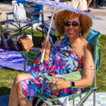 Woman relaxing under a parasol in a lawn chair at Soul Springs Festival