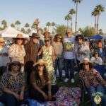 Large group photo at Soul Springs Festival with palm trees in the background