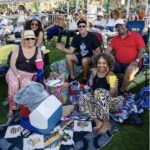 Group of friends seated on a picnic blanket at Soul Springs Festival